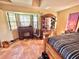 Spacious bedroom with bay window, wooden furniture, and tiled floors at 1424 Breaks Way, Port Orange, FL 32127