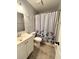 Clean bathroom with a shower/tub and nautical-themed curtain at 15 Richmond Dr, New Smyrna Beach, FL 32169