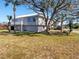 Two-story house with metal roof, balcony, and large yard at 15 Richmond Dr, New Smyrna Beach, FL 32169