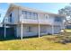 Two-story house with metal roof, balcony, and landscaped lawn at 15 Richmond Dr, New Smyrna Beach, FL 32169