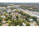 Wide aerial view of the neighborhood with mature trees, homes and nearby commercial area at 1506 Palmetto St, New Smyrna Beach, FL 32168