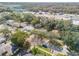 Aerial view of a residential neighborhood with mature trees and nearby commercial area at 1506 Palmetto St, New Smyrna Beach, FL 32168