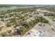 Aerial shot showcases a waterfront community with mature trees, homes, and nearby highway at 1506 Palmetto St, New Smyrna Beach, FL 32168