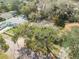 Aerial shot displays the home's location among mature trees in a quiet neighborhood at 1506 Palmetto St, New Smyrna Beach, FL 32168