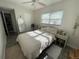 Bright bedroom with ceiling fan, neutral walls, and a sunny window view at 1506 Palmetto St, New Smyrna Beach, FL 32168