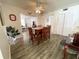 Bright dining area with wood table and chairs, open to living area at 1506 Palmetto St, New Smyrna Beach, FL 32168