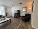 View of the living room, including seating, flooring and entrance to the home at 1506 Palmetto St, New Smyrna Beach, FL 32168