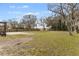 Large backyard with grassy area and trees at 1596 Elizabeth St, New Smyrna Beach, FL 32168