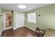 Bedroom with green walls and wood flooring at 1596 Elizabeth St, New Smyrna Beach, FL 32168