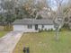 Updated home with driveway, landscaping, and large backyard at 1622 Pine Tree Dr, Edgewater, FL 32132