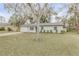 Updated home with driveway, landscaping, and large backyard at 1622 Pine Tree Dr, Edgewater, FL 32132