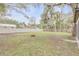 Large backyard with a fire pit and mature trees at 1622 Pine Tree Dr, Edgewater, FL 32132