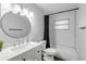 Updated bathroom with a tub, white vanity, and stylish mirror at 1622 Pine Tree Dr, Edgewater, FL 32132