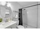 Modern bathroom with a herringbone tile shower and white vanity at 1622 Pine Tree Dr, Edgewater, FL 32132