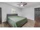 Bright bedroom with a king-size bed and ceiling fan at 1622 Pine Tree Dr, Edgewater, FL 32132