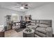 Home office with gray couch, desk, and ceiling fan at 1622 Pine Tree Dr, Edgewater, FL 32132