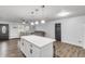 White kitchen island with quartz countertop, open to living area at 1622 Pine Tree Dr, Edgewater, FL 32132