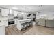 Modern white kitchen with island and stainless steel appliances at 1622 Pine Tree Dr, Edgewater, FL 32132