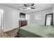 Spacious main bedroom with king bed, dresser, and ceiling fan at 1622 Pine Tree Dr, Edgewater, FL 32132