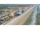 Aerial view of beachfront building and expansive beach at 1705 S Atlantic Ave # 302, New Smyrna Beach, FL 32169