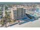 Aerial view of beachfront building, pool, and surrounding area at 1705 S Atlantic Ave # 302, New Smyrna Beach, FL 32169