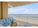 Balcony overlooking the beach with seating for relaxation at 1705 S Atlantic Ave # 302, New Smyrna Beach, FL 32169