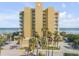 Oceanfront building, featuring a light yellow facade and ample parking at 1705 S Atlantic Ave # 302, New Smyrna Beach, FL 32169