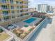 Beachfront pool and hot tub area with lounge chairs at 1705 S Atlantic Ave # 302, New Smyrna Beach, FL 32169