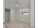 Bright bedroom featuring a ceiling fan and marble-look flooring at 1852 Sabal Palm Dr, Edgewater, FL 32141