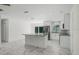 Modern kitchen with white cabinets, large island, and stainless steel appliances at 1852 Sabal Palm Dr, Edgewater, FL 32141