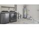 Laundry room with washer, dryer, and storage shelves at 1852 Sabal Palm Dr, Edgewater, FL 32141