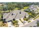 Aerial view of a community of villas with gray roofs and two-car garages at 1938 Turnbull Lakes Dr, New Smyrna Beach, FL 32168