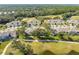 Aerial view of house and surrounding golf course community at 1938 Turnbull Lakes Dr, New Smyrna Beach, FL 32168