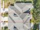 Aerial view showcasing a villa's roofline, backyard, and driveway at 1938 Turnbull Lakes Dr, New Smyrna Beach, FL 32168