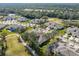 Aerial view of house and surrounding golf course community at 1938 Turnbull Lakes Dr, New Smyrna Beach, FL 32168