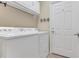 Bright laundry room with washer, dryer, and exterior access at 1938 Turnbull Lakes Dr, New Smyrna Beach, FL 32168