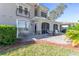 Brick patio with screened porch and comfortable seating at 1938 Turnbull Lakes Dr, New Smyrna Beach, FL 32168