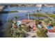 An aerial view of a waterfront home with a pool and private dock at 2 Richmond Dr, New Smyrna Beach, FL 32169