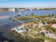 Aerial view showcasing waterfront property, private dock, and swimming pool at 2 Richmond Dr, New Smyrna Beach, FL 32169