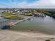 Aerial view of waterfront home with private dock and sandy beach at 2 Richmond Dr, New Smyrna Beach, FL 32169