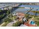 Aerial view of waterfront home, pool, and private dock, near bridge at 2 Richmond Dr, New Smyrna Beach, FL 32169