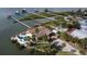 Aerial view featuring a home with a backyard pool, long docks and a beautiful view of a canal and bay at 2 Richmond Dr, New Smyrna Beach, FL 32169