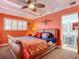 Soothing bedroom with orange walls and a wooden sleigh bed at 2 Richmond Dr, New Smyrna Beach, FL 32169