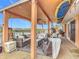 Relaxing waterfront patio with wicker furniture and ceiling fan at 2 Richmond Dr, New Smyrna Beach, FL 32169