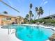 Inviting kidney-shaped pool with lounge chairs and palm trees at 2 Richmond Dr, New Smyrna Beach, FL 32169