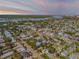 An aerial view of a coastal community with lush trees, nearby bridges and bay views at 201 S Cooper St, New Smyrna Beach, FL 32169