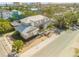 Two-story house with a metal roof, and a landscaped yard; ocean view in the background at 201 S Cooper St, New Smyrna Beach, FL 32169