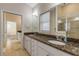 Double vanity bathroom with granite countertop and a large walk-in shower at 201 S Cooper St, New Smyrna Beach, FL 32169