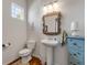 Elegant bathroom with pedestal sink and decorative mirror at 201 S Cooper St, New Smyrna Beach, FL 32169