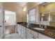 Double vanity bathroom with granite countertop and a large walk-in shower at 201 S Cooper St, New Smyrna Beach, FL 32169